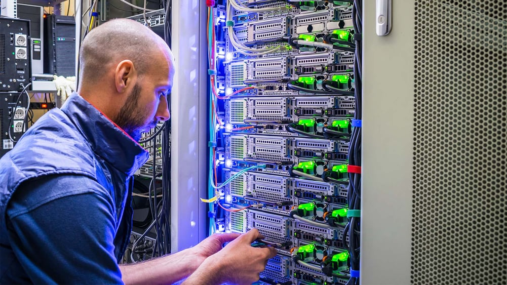 Engineer inspecting server cables