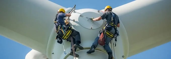 Men fixing wind turbine