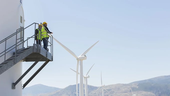 Men overlooking wind farm