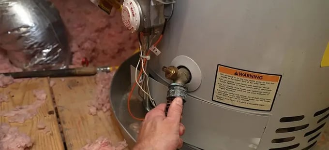 Tanked water heater being repaired